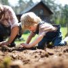 Father with small son working outdoors in garden, sustainable lifestyle concept.